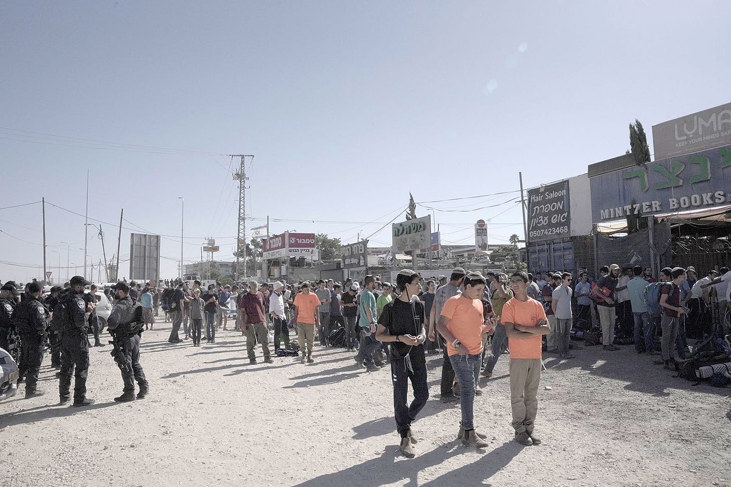 Nachala activists gather in a staging area while border police watch over. (Photo by Natan Odenheimer)