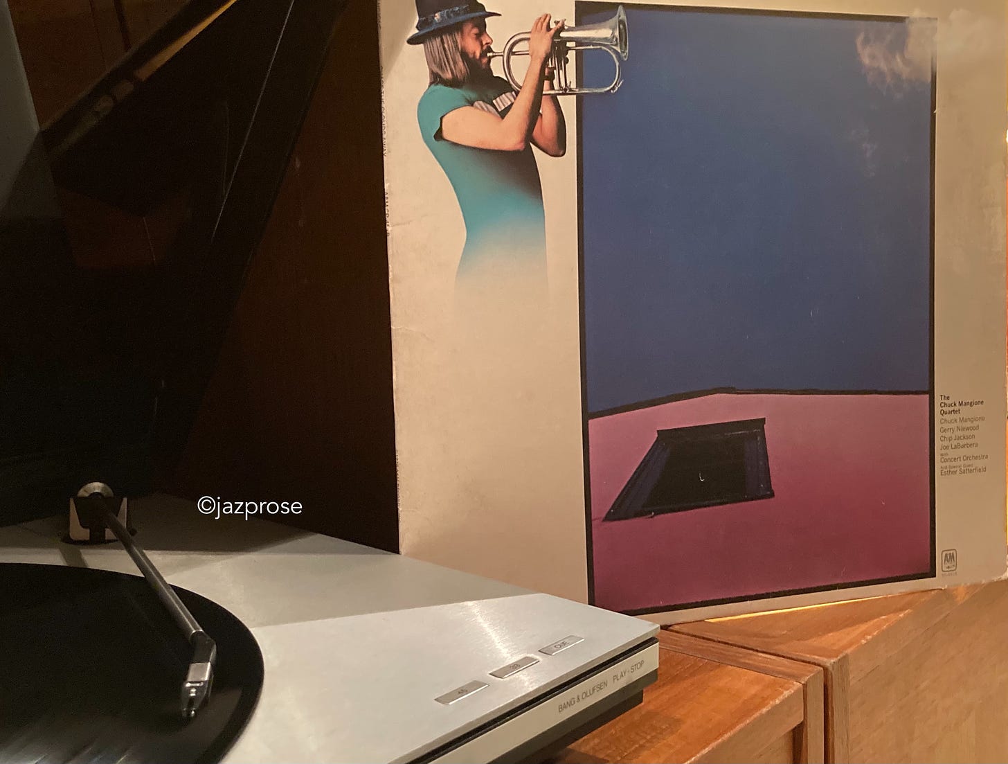 Photo of turntable and album cover showing a man wearing a hat and playing a wind instrument.