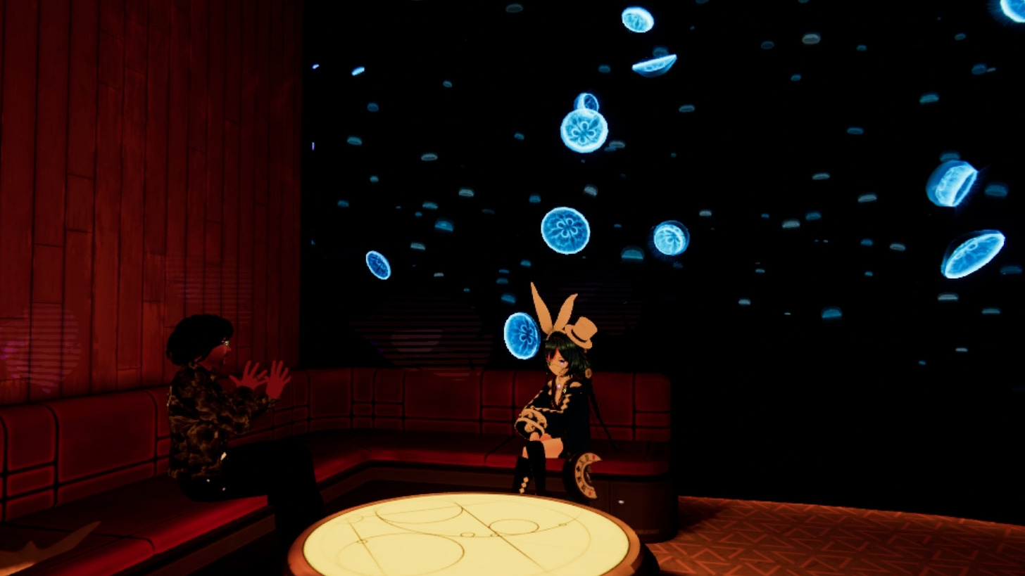 This is an image of ArmaniXR and Fins sitting on the couch in a room in front of multiple jellyfish.