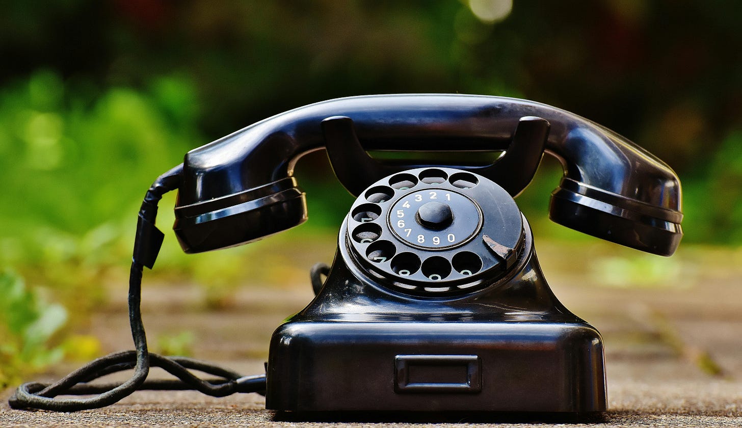 Old-style black rotary landline phone. Old-style black rotary landline phone.