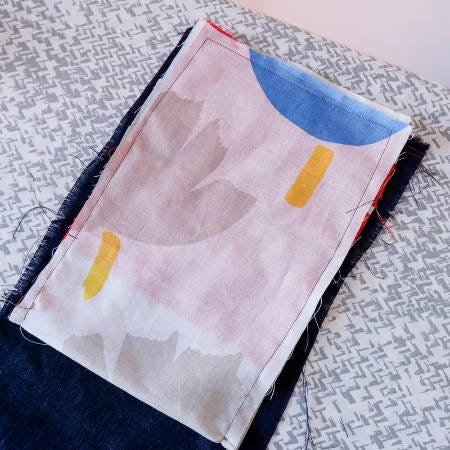 a sewn pocket in white fabric with a print