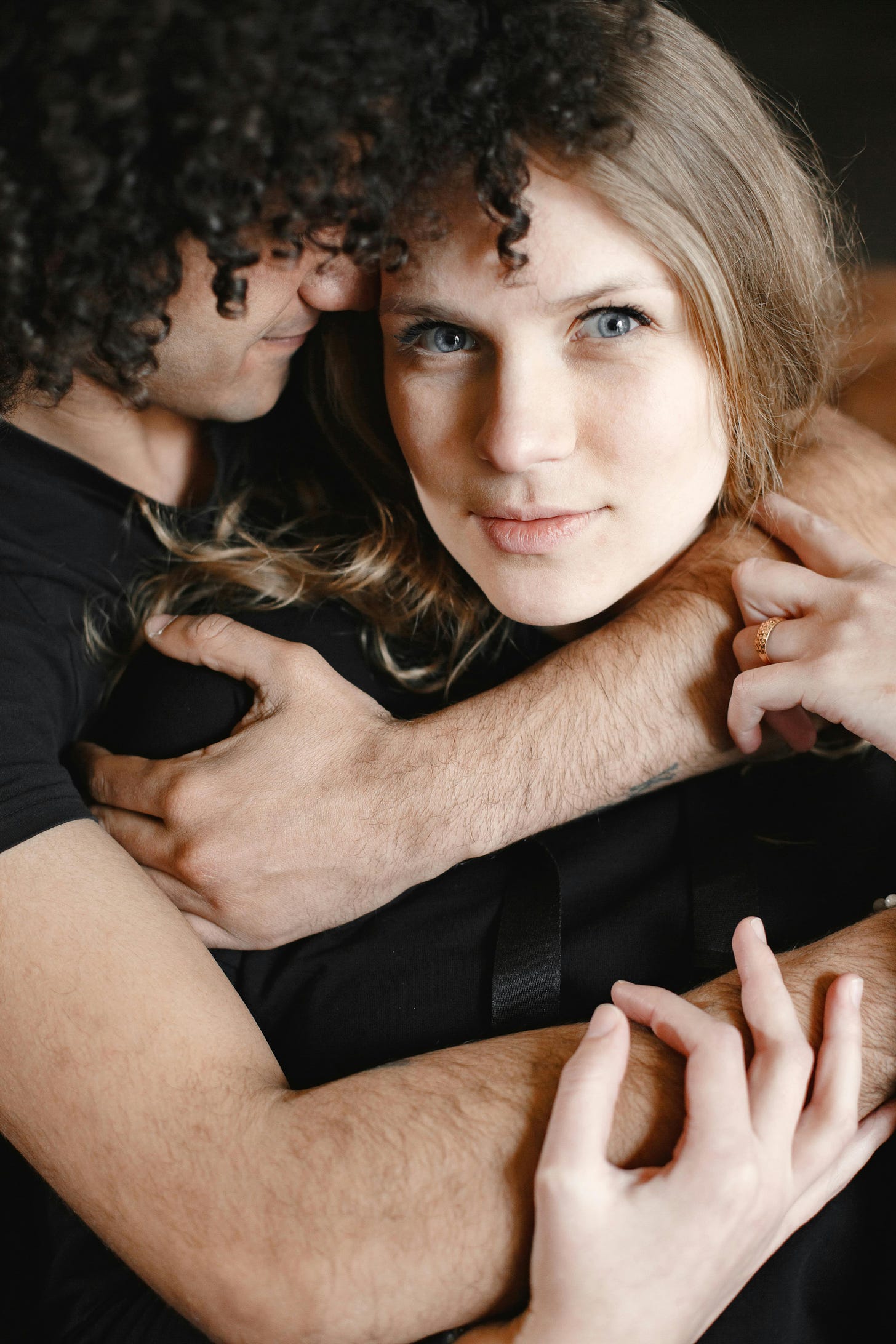 Man on left hugging woman, right with face close up