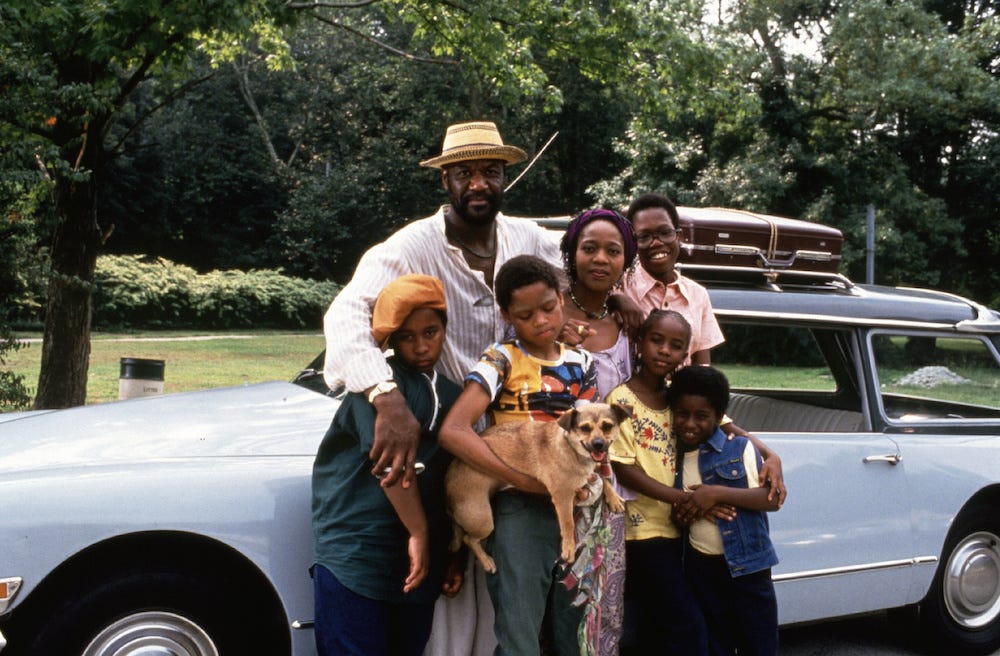 Delroy Lindo, Alfre Woodard and five kids in front of a car, from Spike Lee's Crooklyn.