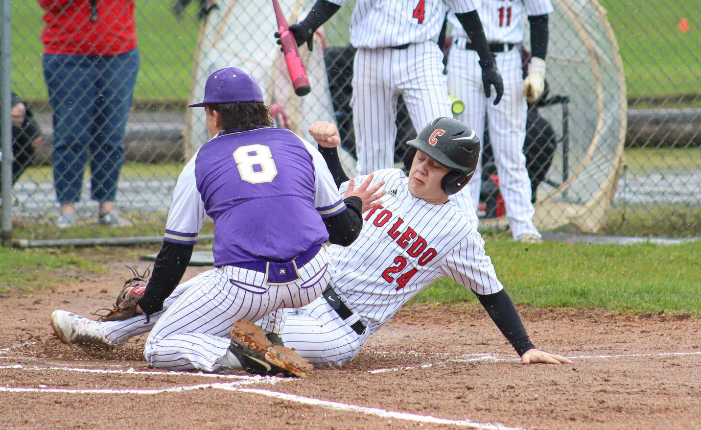 Toledo's Bode Buswell (24) slides into home past Onalaska's Desean Stewert (8) at Toledo High School on Friday, March 14. Toledo's Bode Buswell (24) slides into home past Onalaska's Desean Stewert (8) at Toledo High School on Friday, March 14.