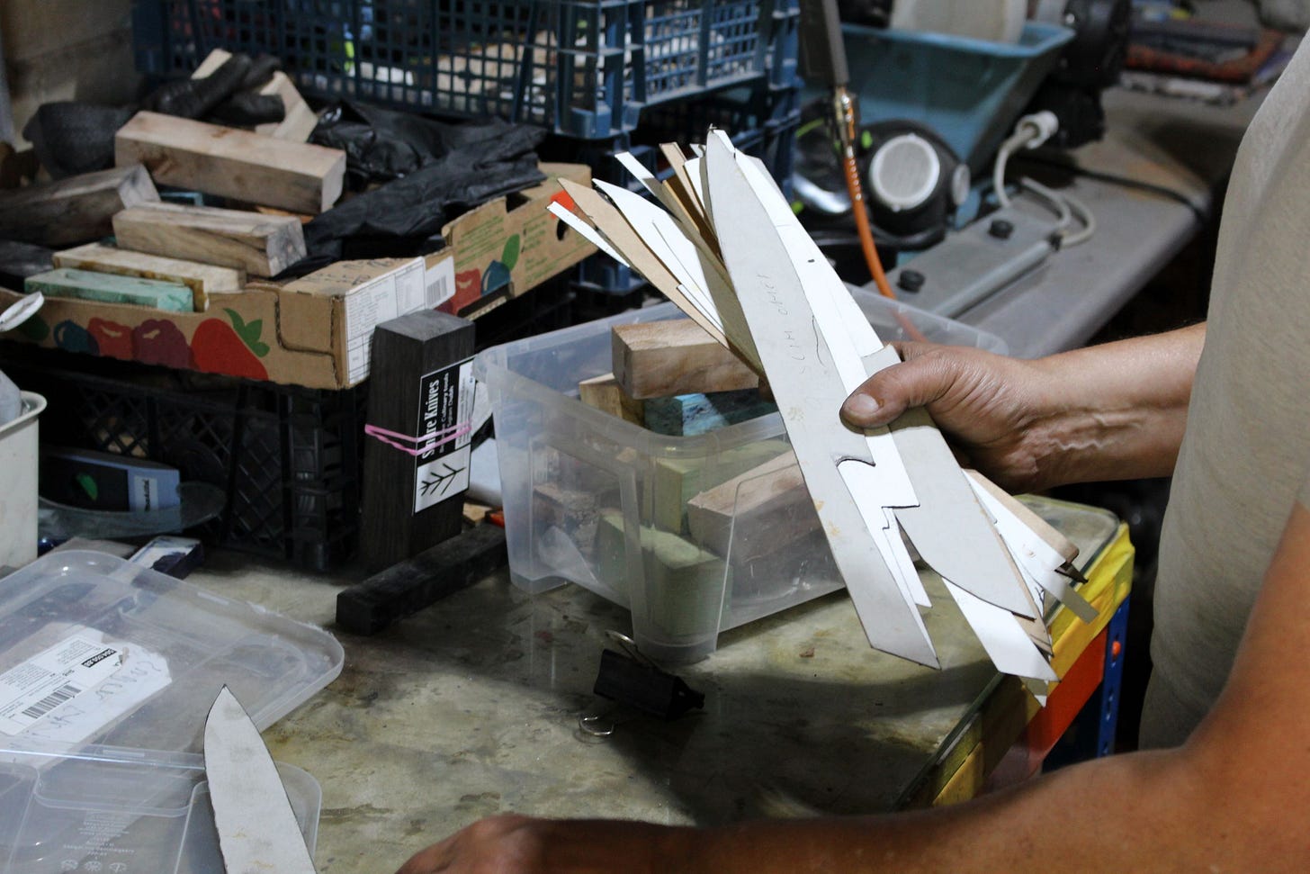 Bernard holding a fan of cardboard knife templates