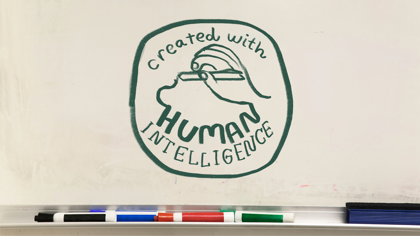 "Created with Human Intelligence" on a dry erase whiteboard.