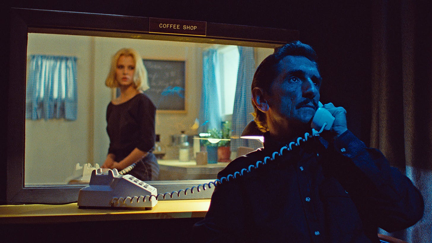 Paris, Texas | Still features Harry Dean Stanton speaking over a phone to Nastassja Kinski at a peep show through a one-way mirror.