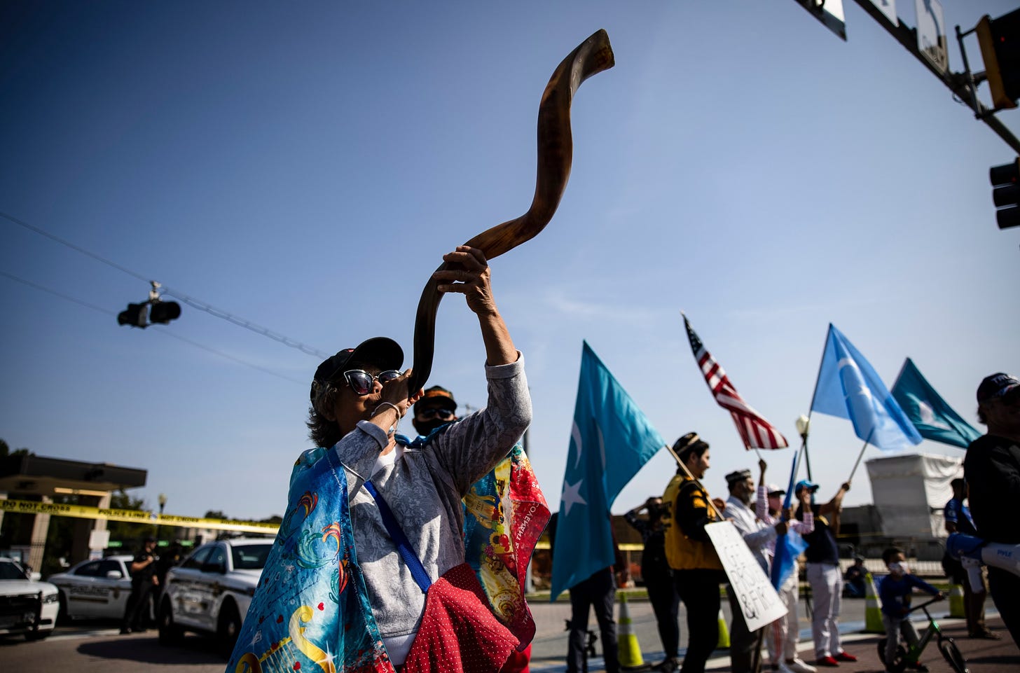 A woman blows a shofar outside of Walter Reed National Military Medical Center after the president was admitted for treatment of Covid-19 on October 4, 2020 in Bethesda, Maryland. Shofars were present at the pro-Trump “Jericho March” in DC on January 6 as well.