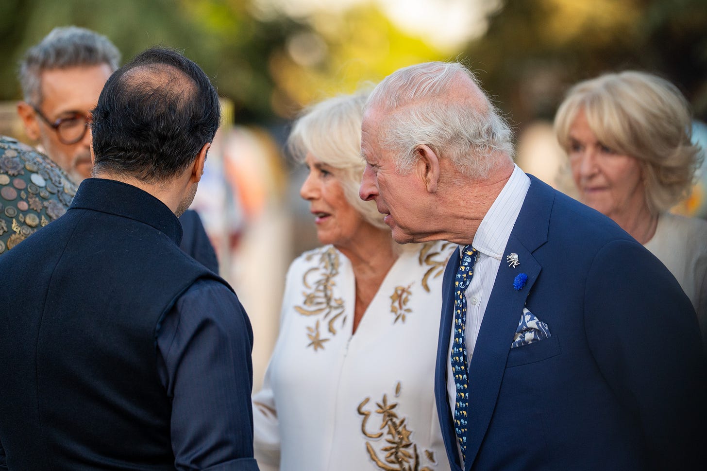 King Charles with Camilla and her sister talking to guests at Buckingham Palace