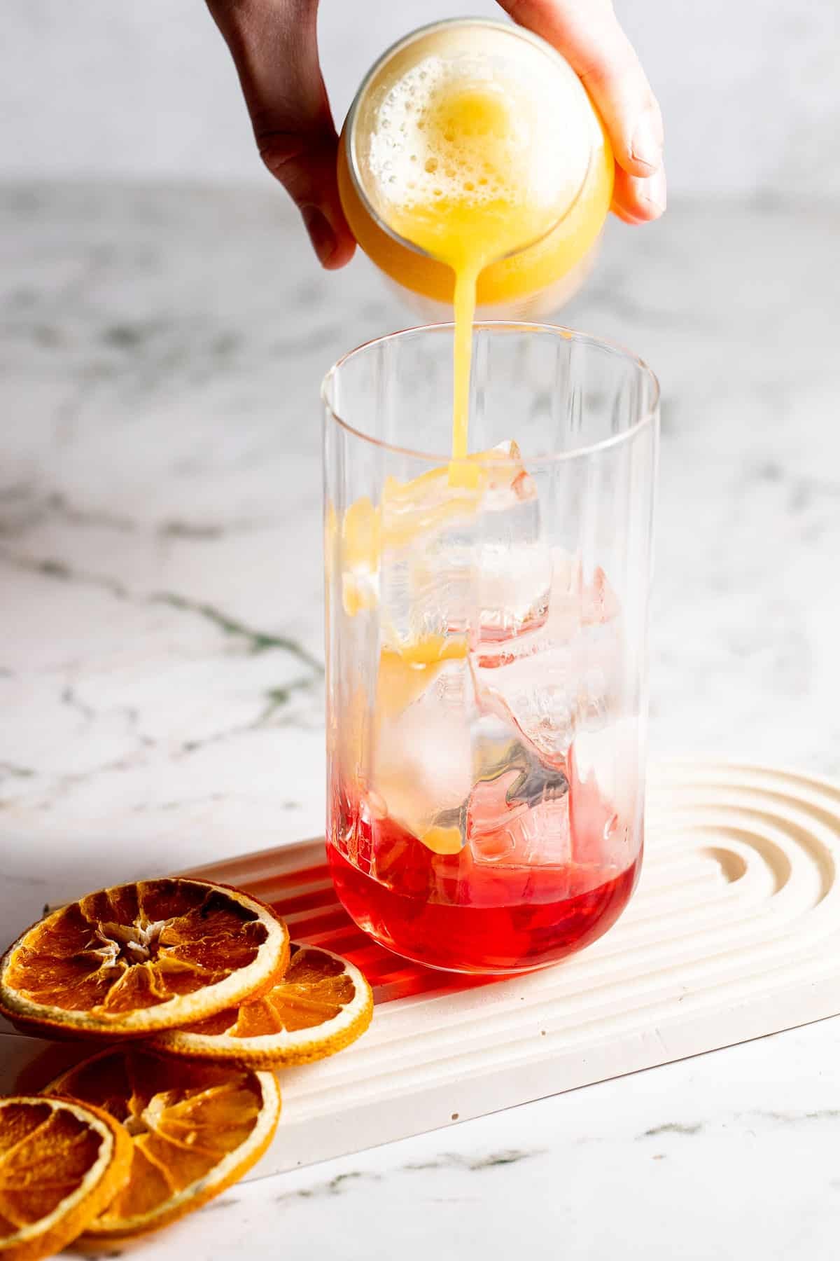 adding orange juice to campari