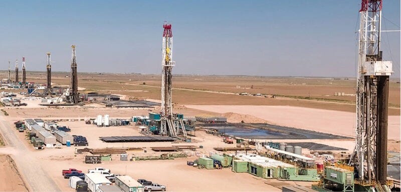 A row of drilling rigs help form what is known as a cube development in the Permian Basin. A row of drilling rigs help form what is known as a cube development in the Permian Basin.