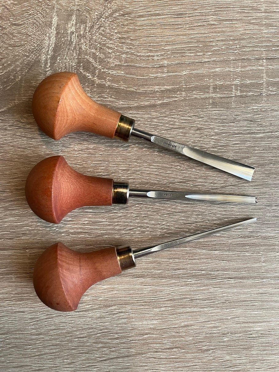 Photo: Three lino carving tools.