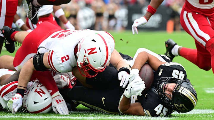 Sep 28, 2024; West Lafayette, Indiana, USA;  Purdue Boilermakers running back Devin Mockobee (45) is tackled by Nebraska Cornhuskers defensive back Isaac Gifford (2) during the second quarter at Ross-Ade Stadium.