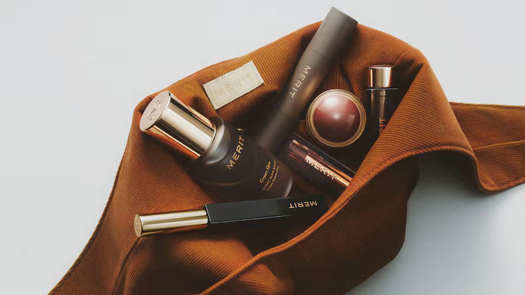 Merit Beauty products in the brand's signature bag.