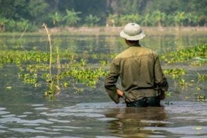 Man wading in thigh hiigh water