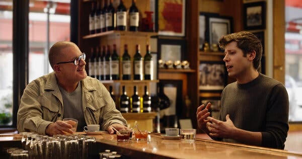 Mr. Ive and Mr. Altman sitting at a bar while talking to each other.
