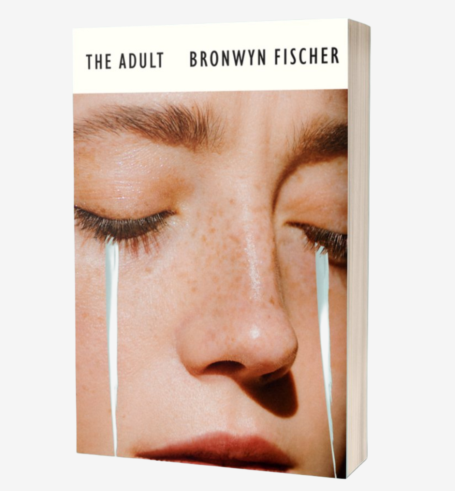 Paperback edition of The Adult by Bronwyn Fischer (title and text against a white banner above a close-up picture of a young white woman’s face with blonde eyebrows and freckles across the nose, with two long, pale-blue watercolor streaks emerging from her mostly-closed eyes to mimic tears)