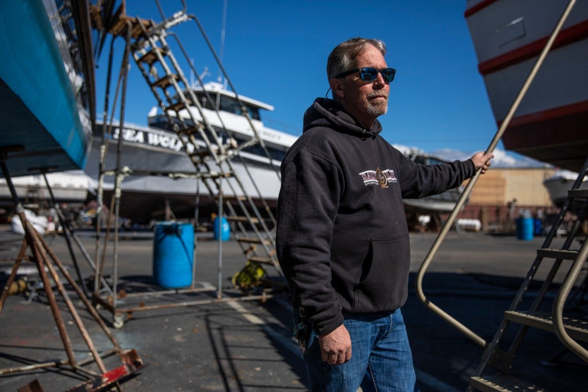 Jared Davis stands beside his boat, the Salty Lady, as it sits in dry dock in Richmond on Mar. 8, 2023. Photo by Martin do Nascimento, CalMatters