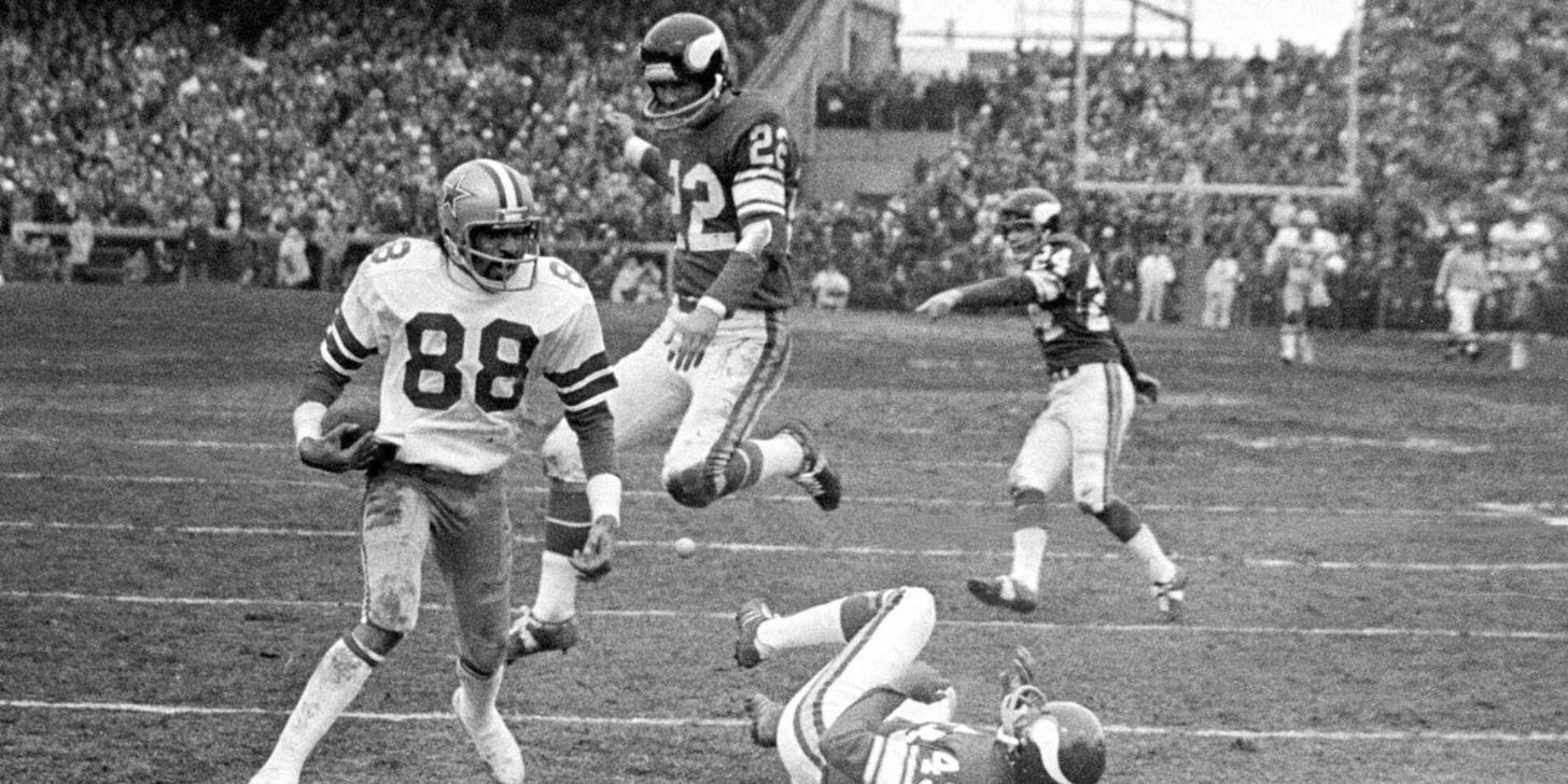 In this Dec. 28, 1975, file photo, Dallas Cowboy wide receiver Drew Pearson (88) nears the end zone on a game-winning 50-yard touchdown pass play in the fourth quarter of an NFL football game against the Minnesota Vikings in Bloomington, Minn. Cowboys quarterback Roger Staubach explained his game-winning throw by saying, "I closed my eyes and said a Hail Mary. Staubach and Pearson have connected again as part of a project to create a digital collectible of their famous Hail Mary for the Dallas Cowboys against Minnesota in 1975. It's part of an emerging product in sports memorabilia called non-fungible tokens, or NFTs. (AP Photo/File)