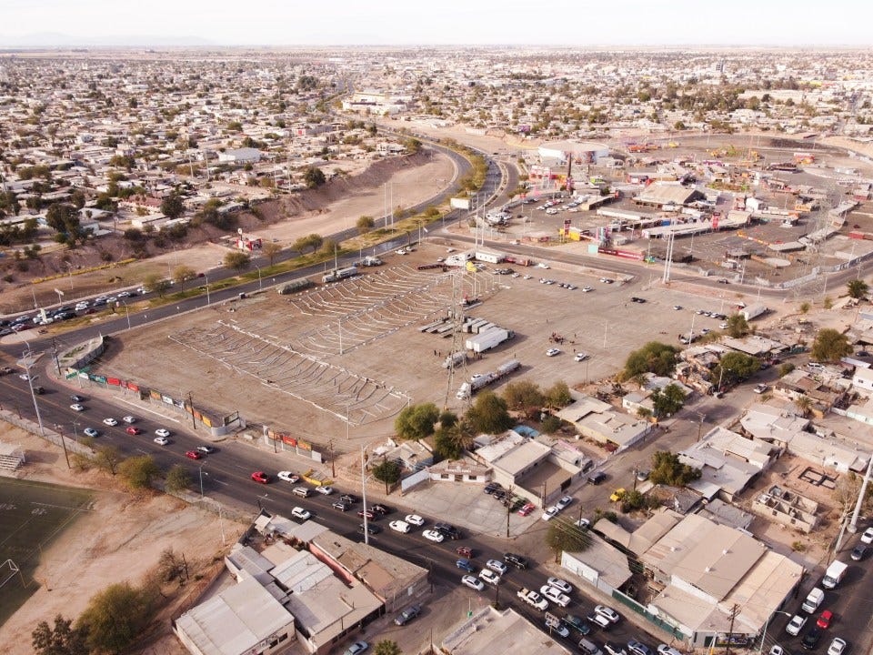 Aerial view of workers setting up a temporary migrant shelter in Mexicali, Mexico. Aerial view of workers setting up a temporary migrant shelter in Mexicali, Mexico.
