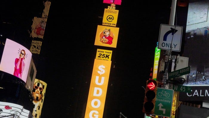 A billboard in Times Square in New York displays signs for Dogecoin in 2021
