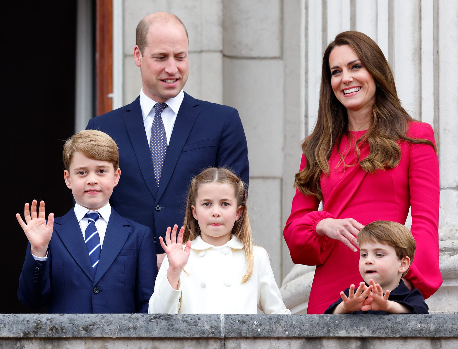 Prince William stood next to Kate Middleton on a balcony, with children: Prince Louis, Princess Charlotte and Prince George waving 