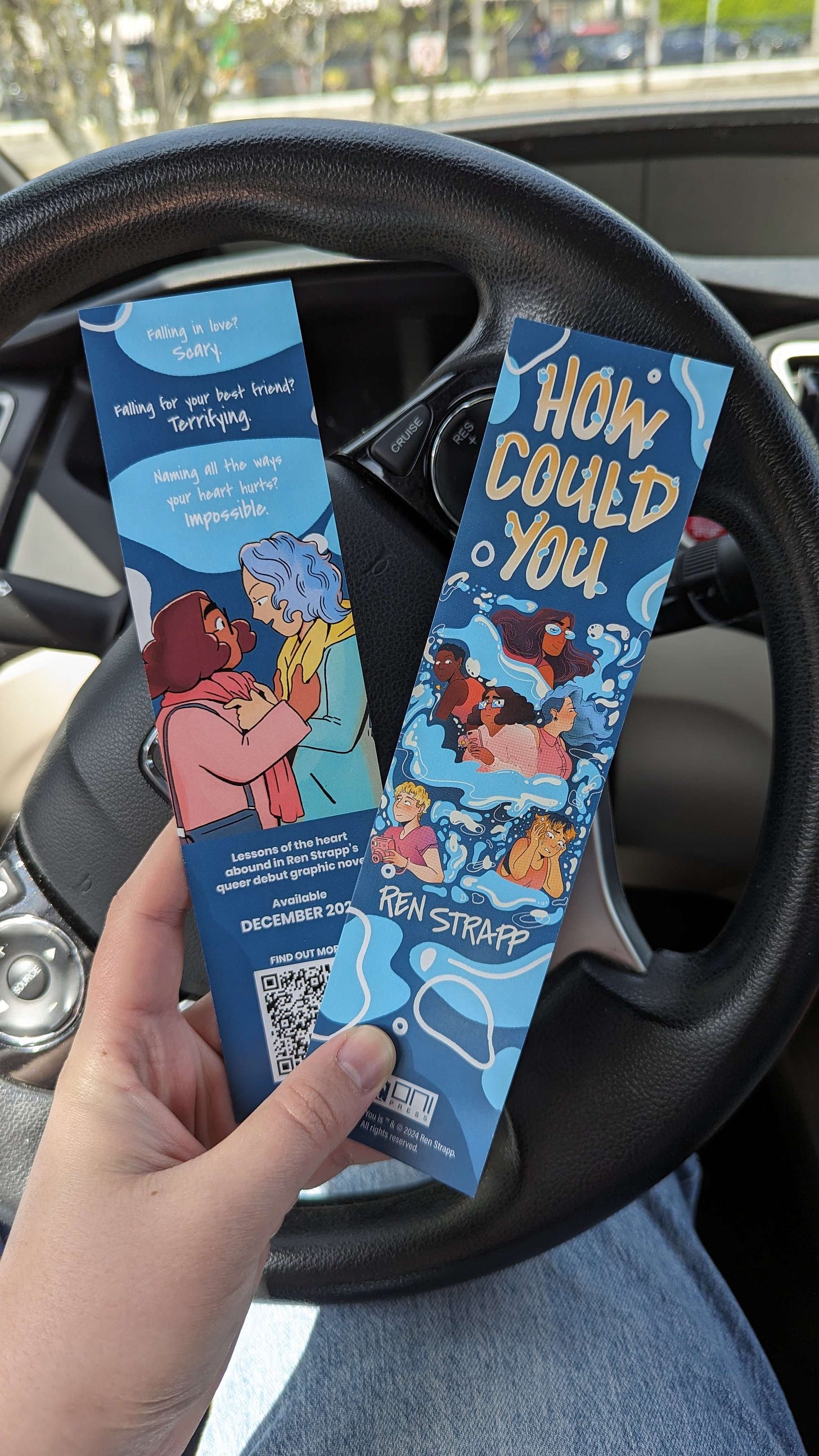 Photograph of two blue bookmarks (front and back) promoting How Could You