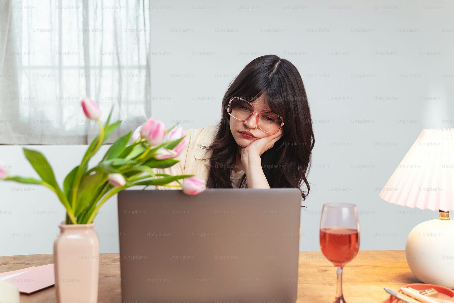 a woman sitting in front of a laptop computer