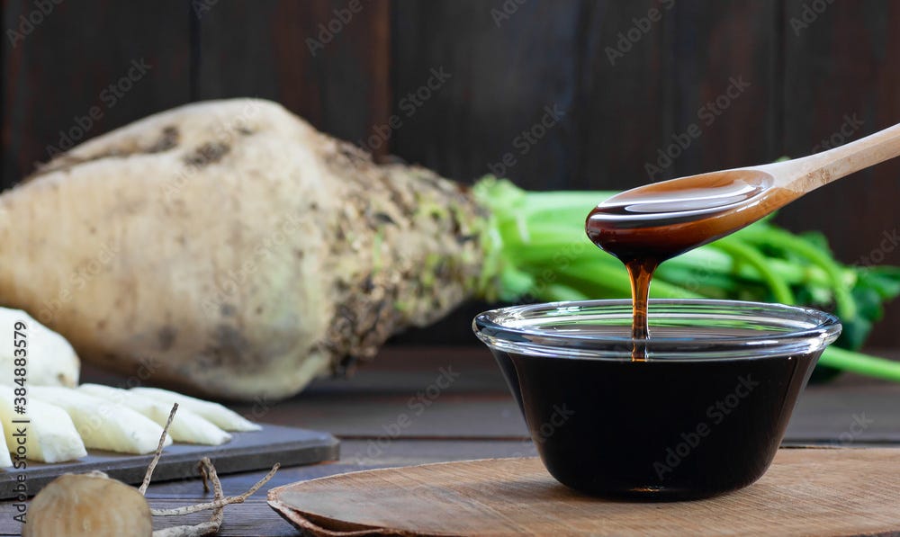 Sugar beet molasses in glass bowl with fresh sugar beetroot plant, healthy  food, beta vulgaris Stock-Foto | Adobe Stock