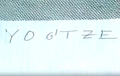 image of a piece of paper with YOG TZE written on it