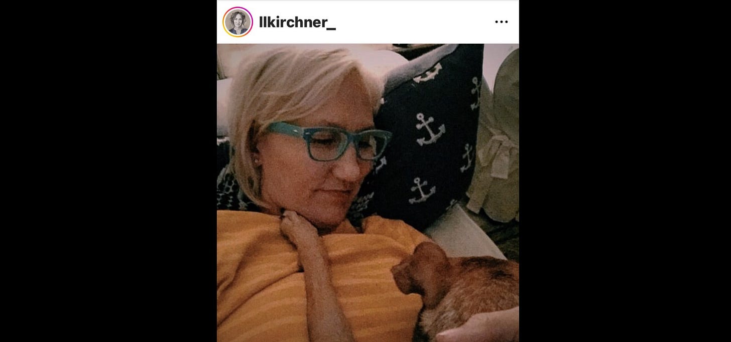 LL Kirchner reclined with Hartley on her lap, one paw reaching for her shoulder.