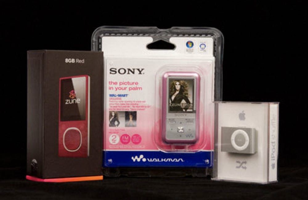 A photo showing the Zune, Sony Walkman and iPod Shuffle, side by side