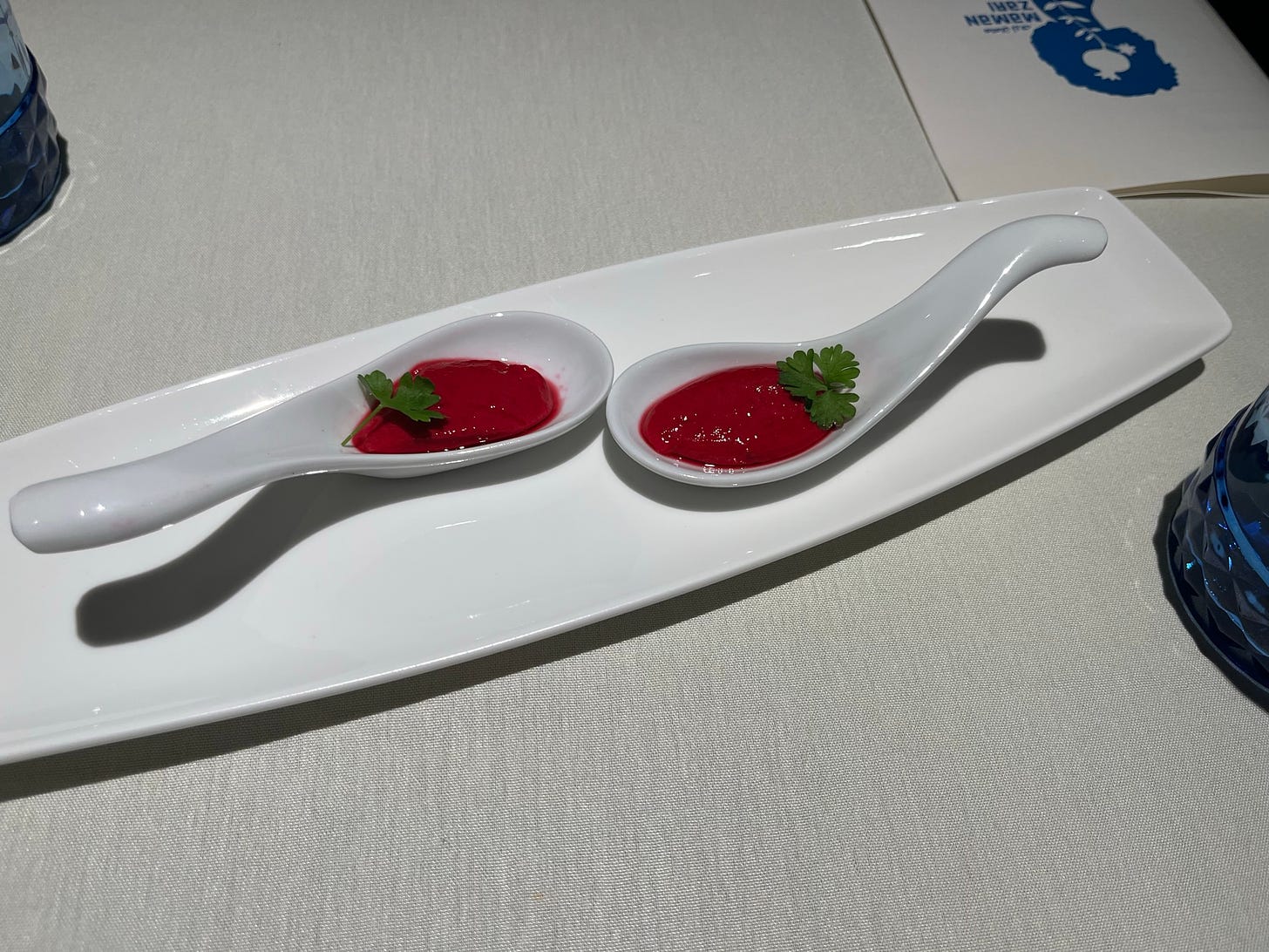 Beet-red pudding with parsley on big spoons