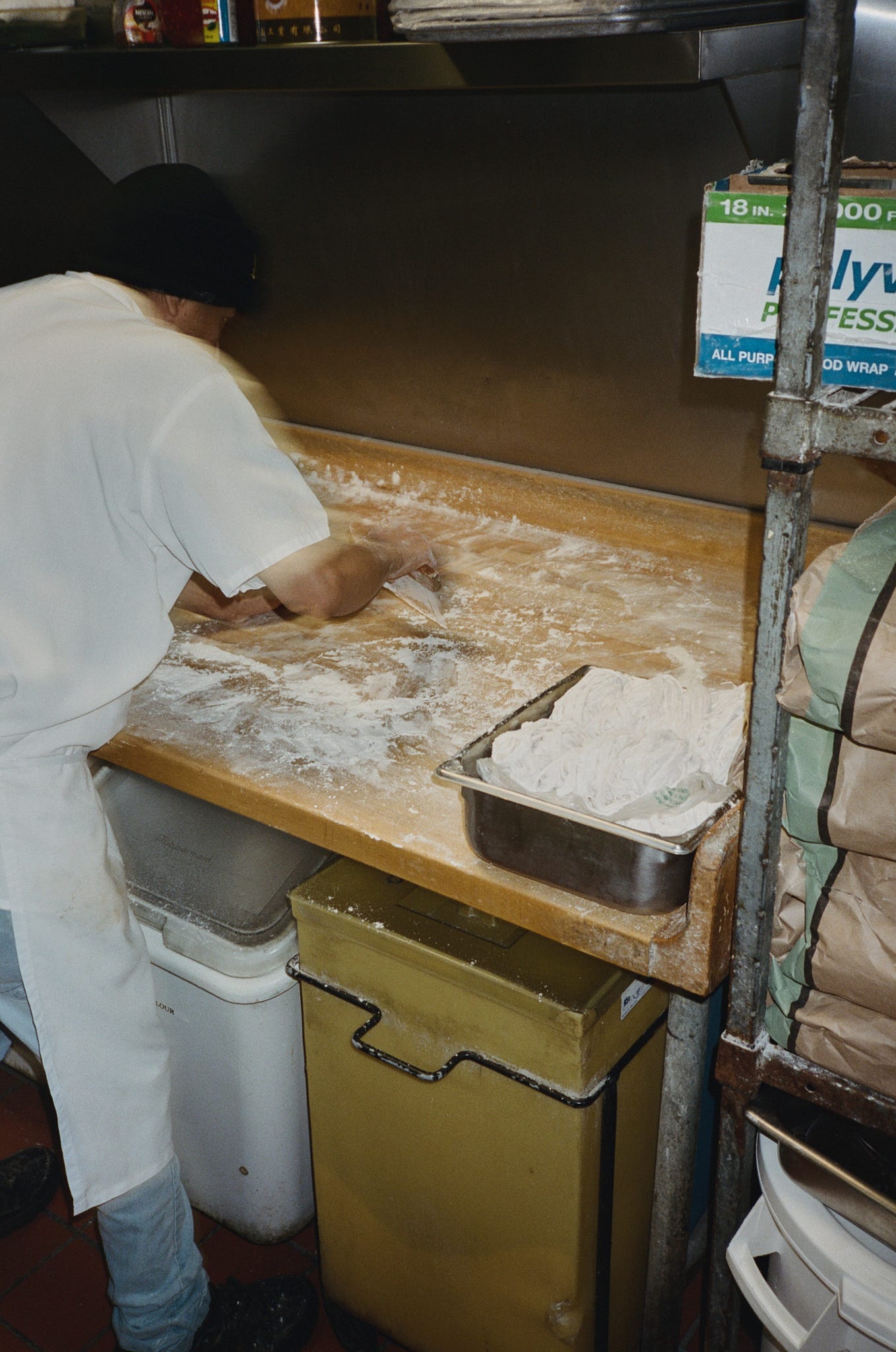 A cook hand pulling noodles.