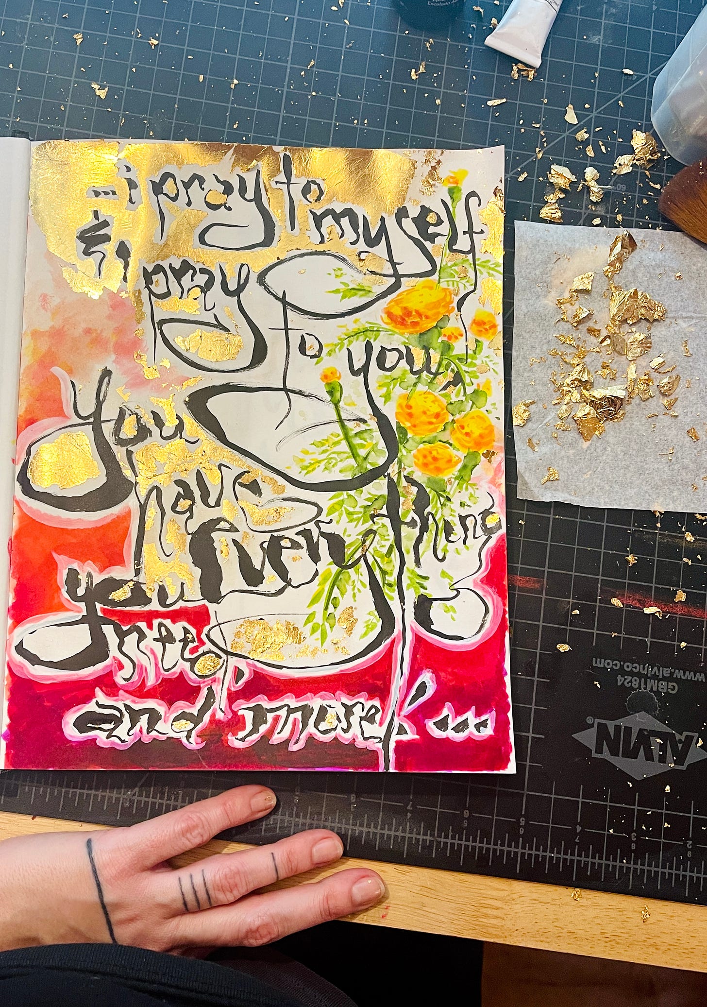 gold leaf sketchbook page reading "...i pray to myself & i pray to you you have everything you need and more!..." surrounded by red watercolor and illustrated marigolds