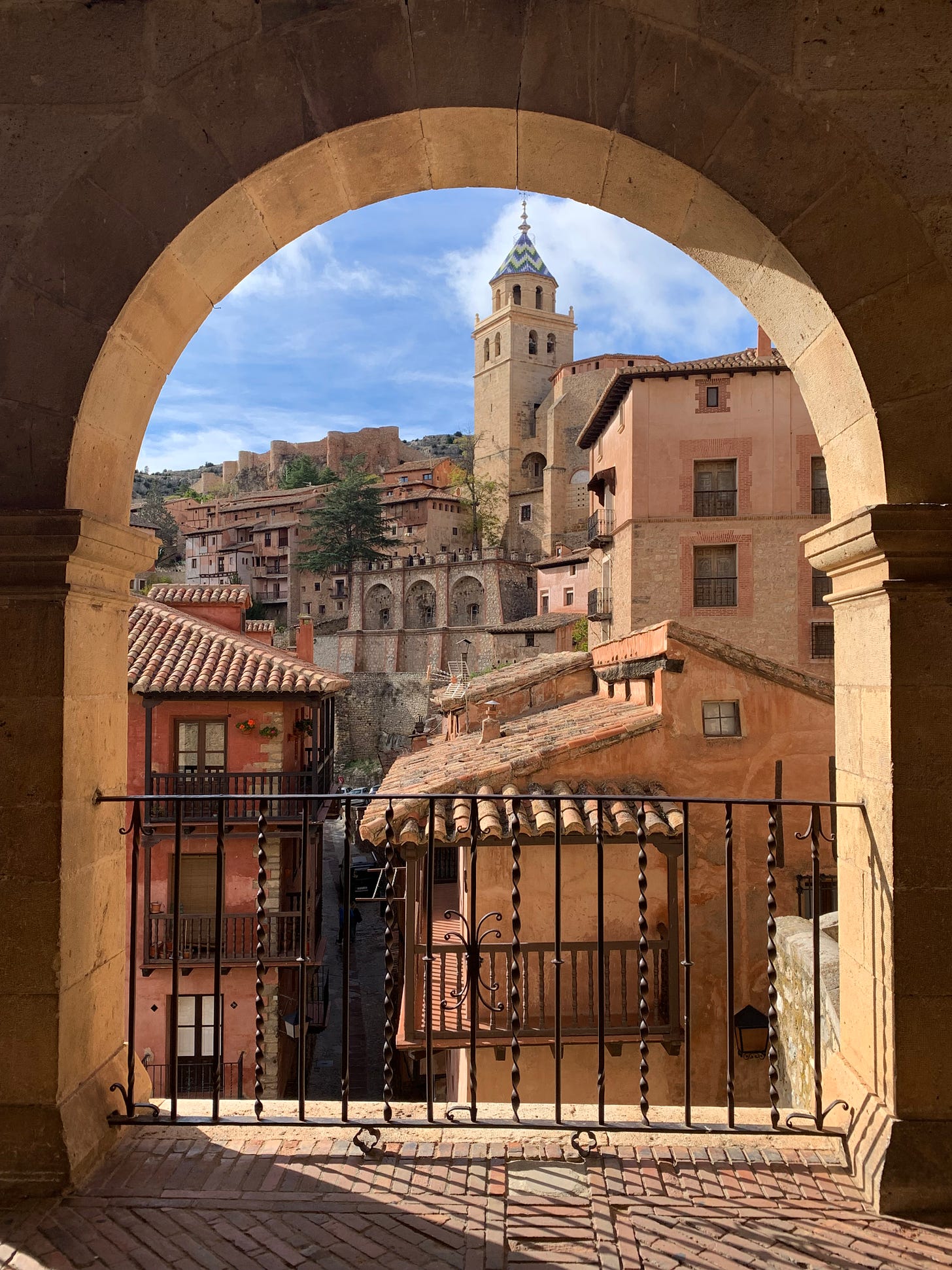 a view of the town and cathedral through an archway