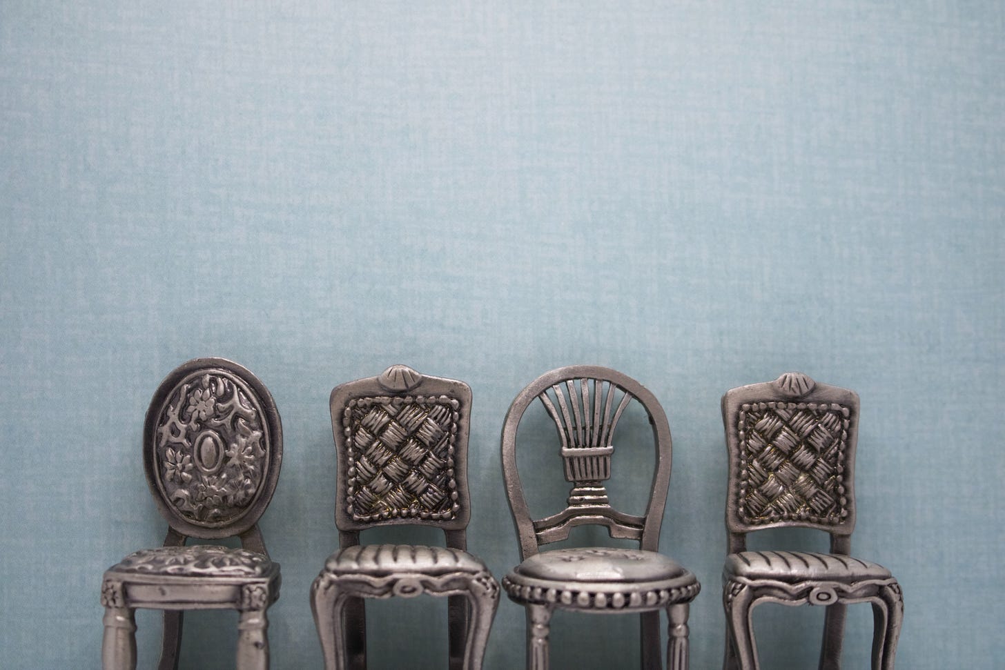 Metal chairs in front of blue background