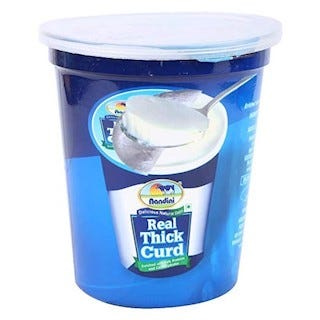 Nandini yogurt container with a lid.