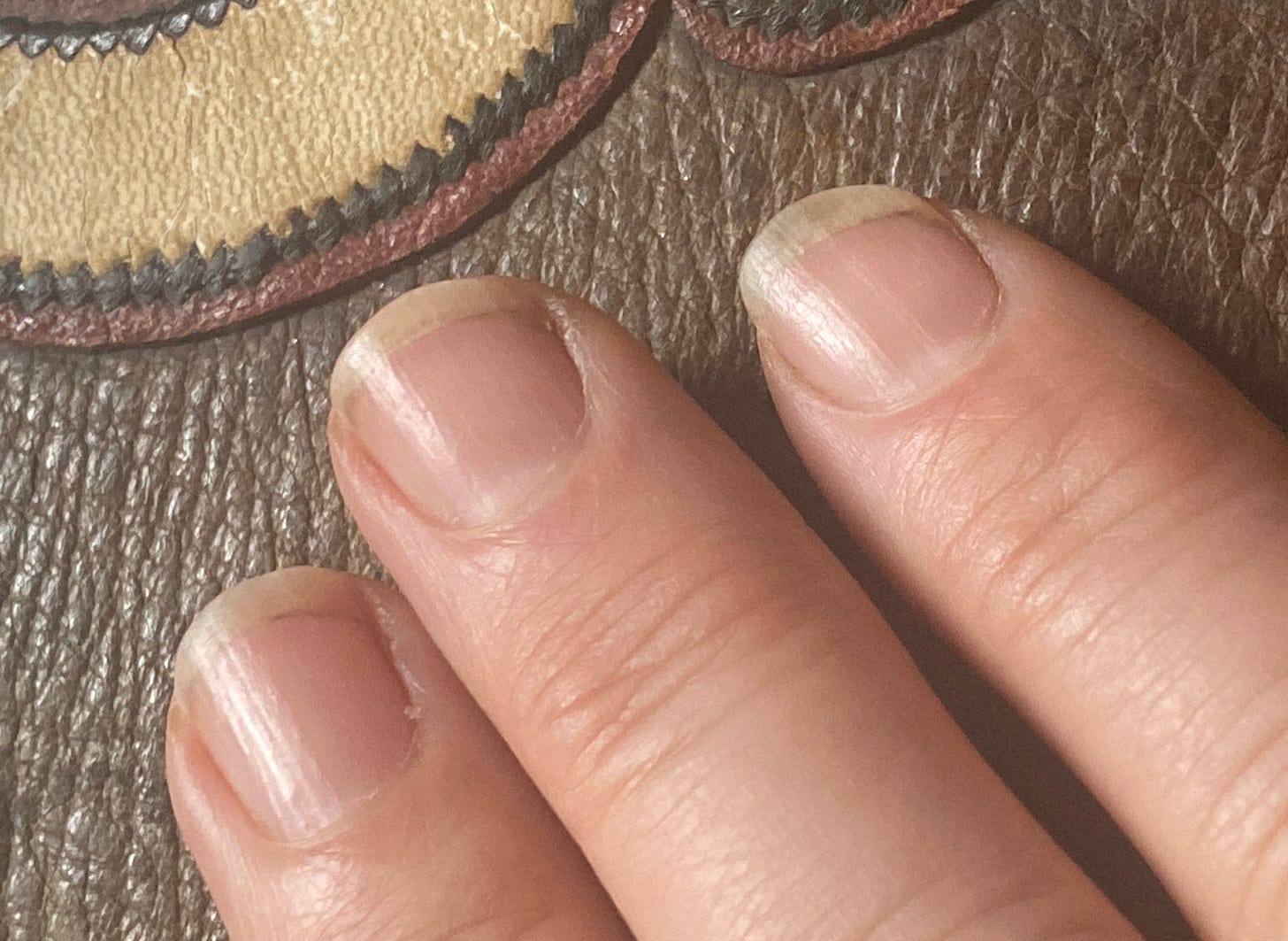 three slightly dirty finger fingernails