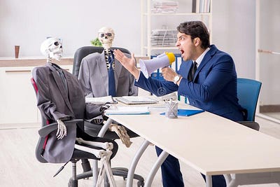 A businessman in a meeting yellowing at inattentive stakeholders.