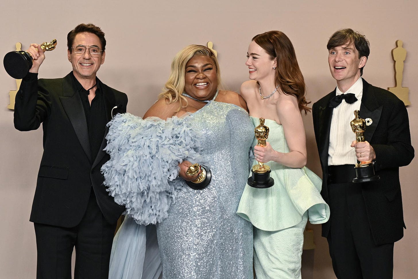 Robert Downey Jr., Da'Vine Joy Randolph, Emma Stone, and Cillian Murphy hold their acting Oscars. 