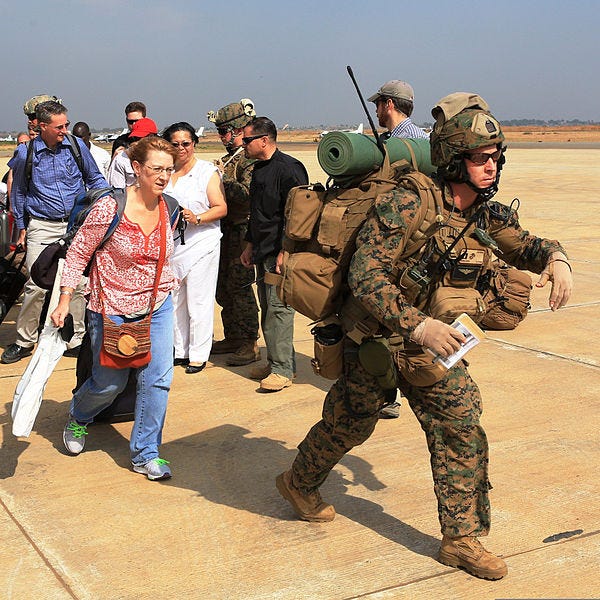 File:A U.S. Marine, right, assigned to Special Purpose Marine Air-Ground Task Force Crisis Response, guides U.S. citizens down a flight line in Juba, South Sudan, during an evacuation of personnel from the U.S 140103-M-HF911-006.jpg