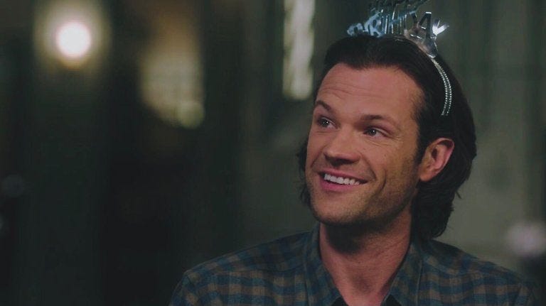 Sam Winchester smiling with birthday hat on SPN