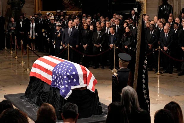 A coffin draped with the US Flag; President Jimmy Carter Lying in State at the National Capital, Washington D.C. 