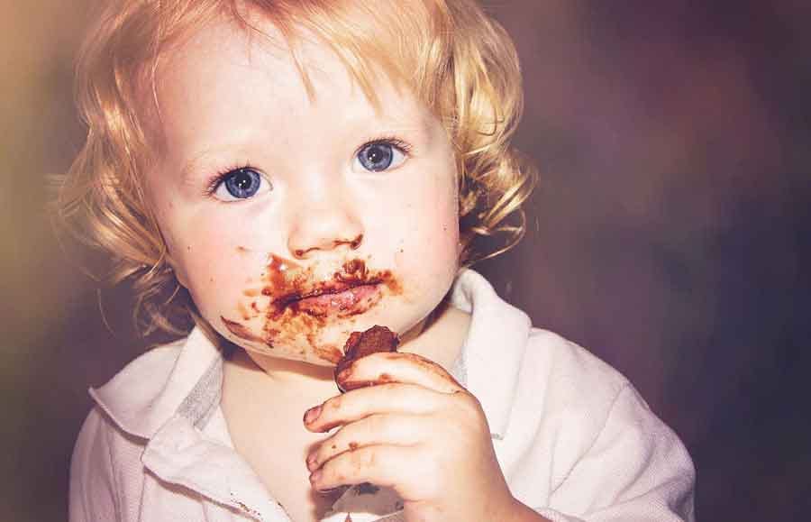 child eating chocolate