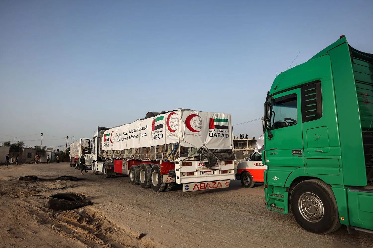 Trucks carrying humanitarian aid enter the Gaza Strip via the Rafah crossing with Egypt on the third day of a truce between Israel and Hamas on November 26, 2023.