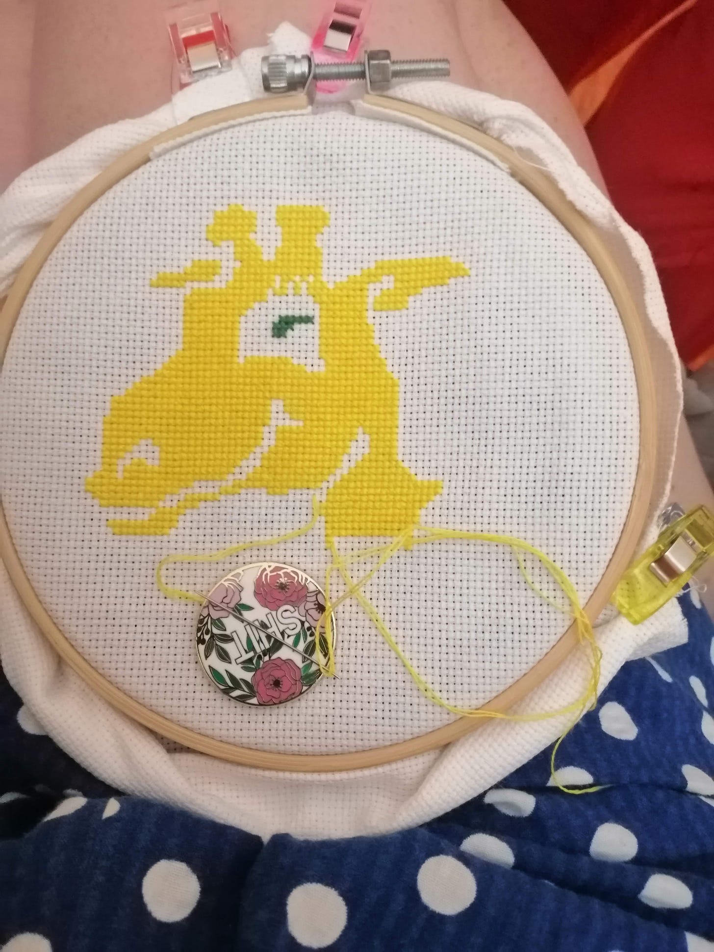 Work in progress cross-stitch of just the yellow parts of a giraffe's head