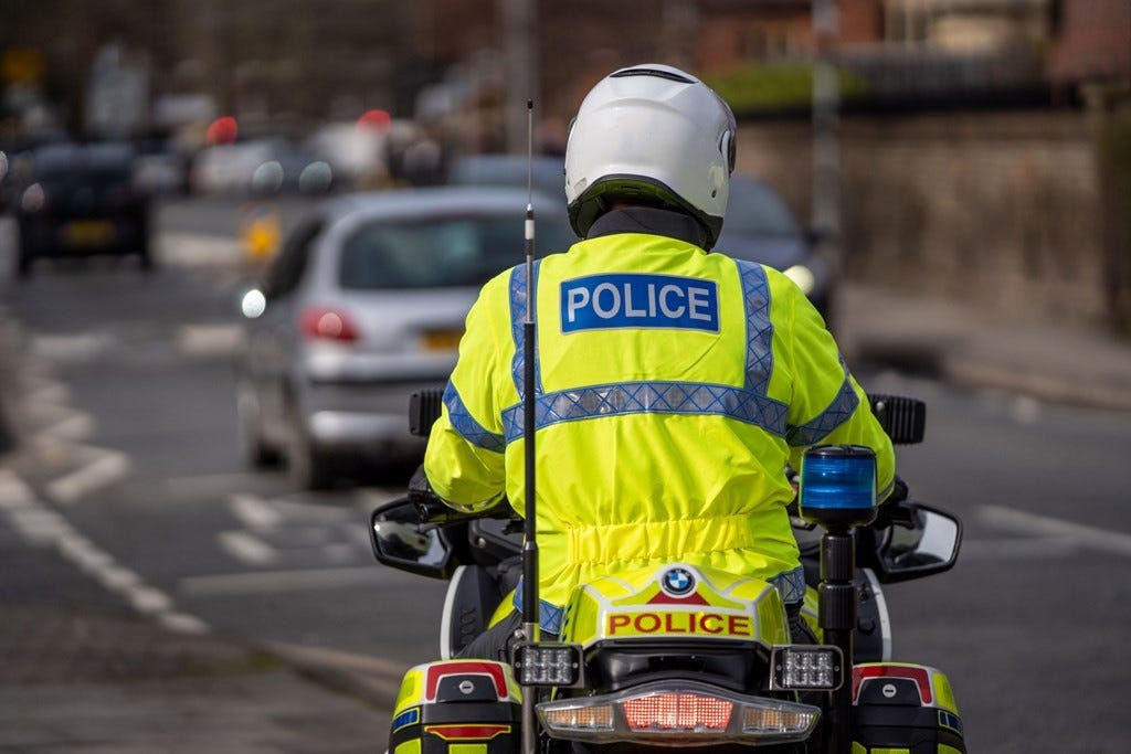 Police motorcyclist on a busy road