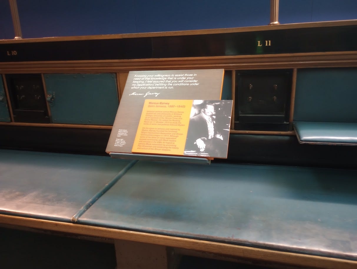 Small info panel on Marcus Garvey with brief text, quote, and photos, set in an old British Library carrel, or enclosed desk