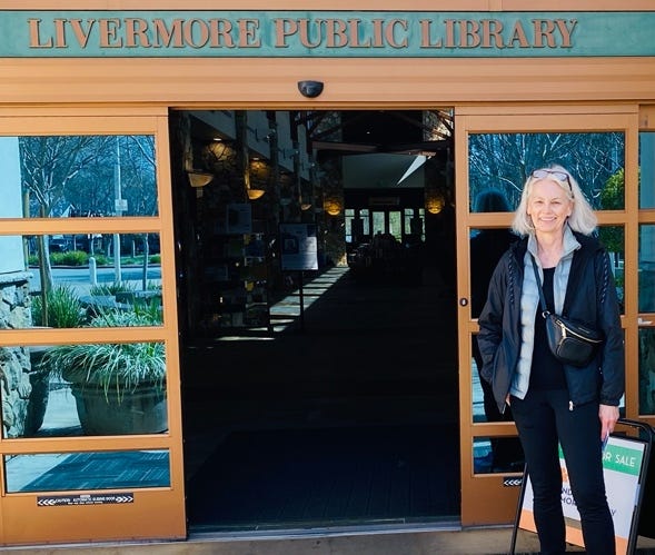 A person standing in front of a library

Description automatically generated